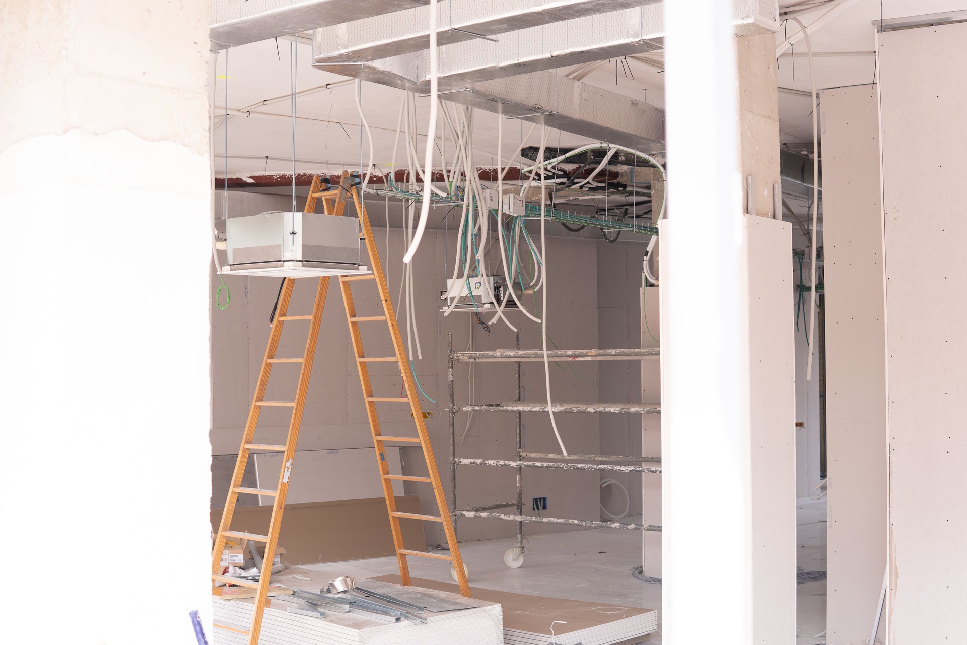 interior of a local in works of rehabilitation and conditioning with wiring stairs scaffolding air conditioning ducts. for business cafeteria. Concept construction and renovation company.